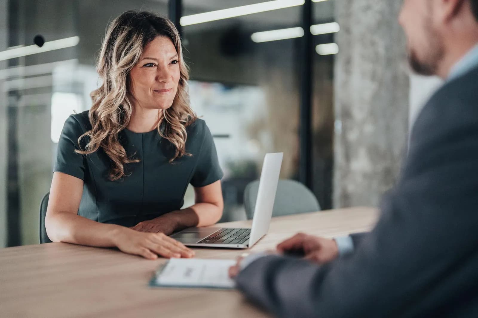 Independent consultant working on a laptop in a meeting