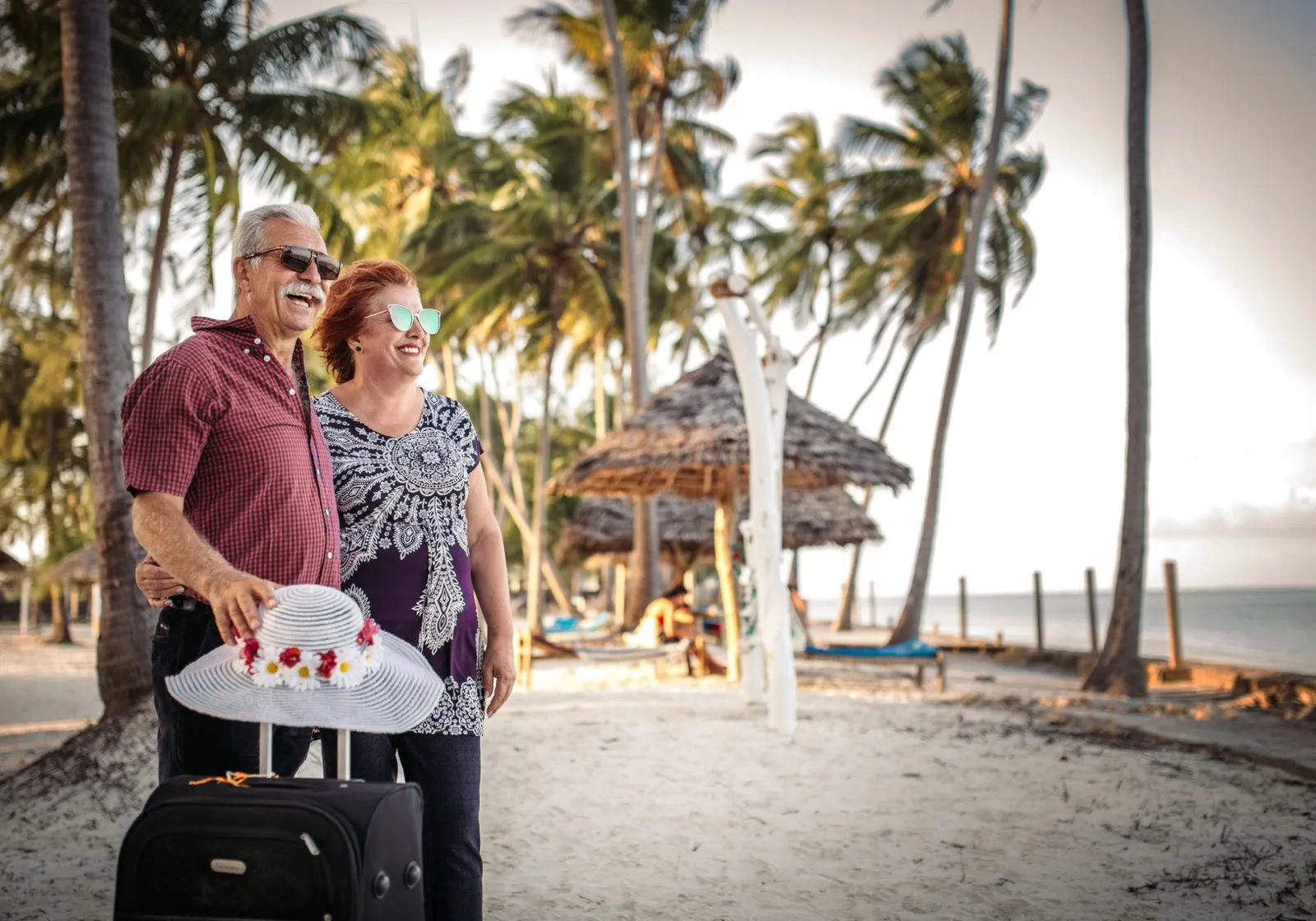 Happy early-retiree couple enjoying a beach vacation