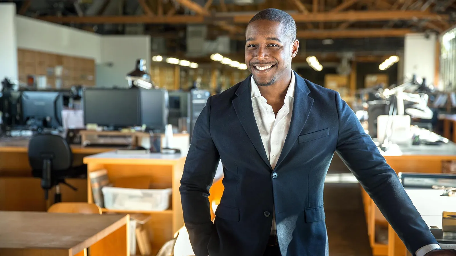 Entrepreneur standing confidently in a startup office