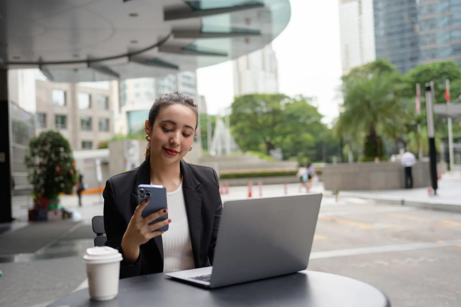 Gig worker checking earnings on a laptop outdoors
