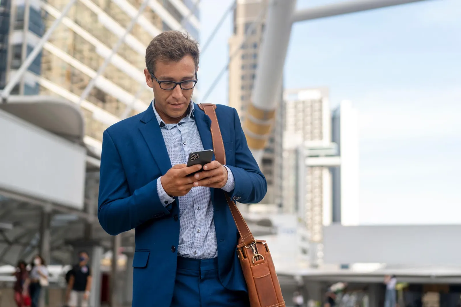 Independent courier on his phone between deliveries