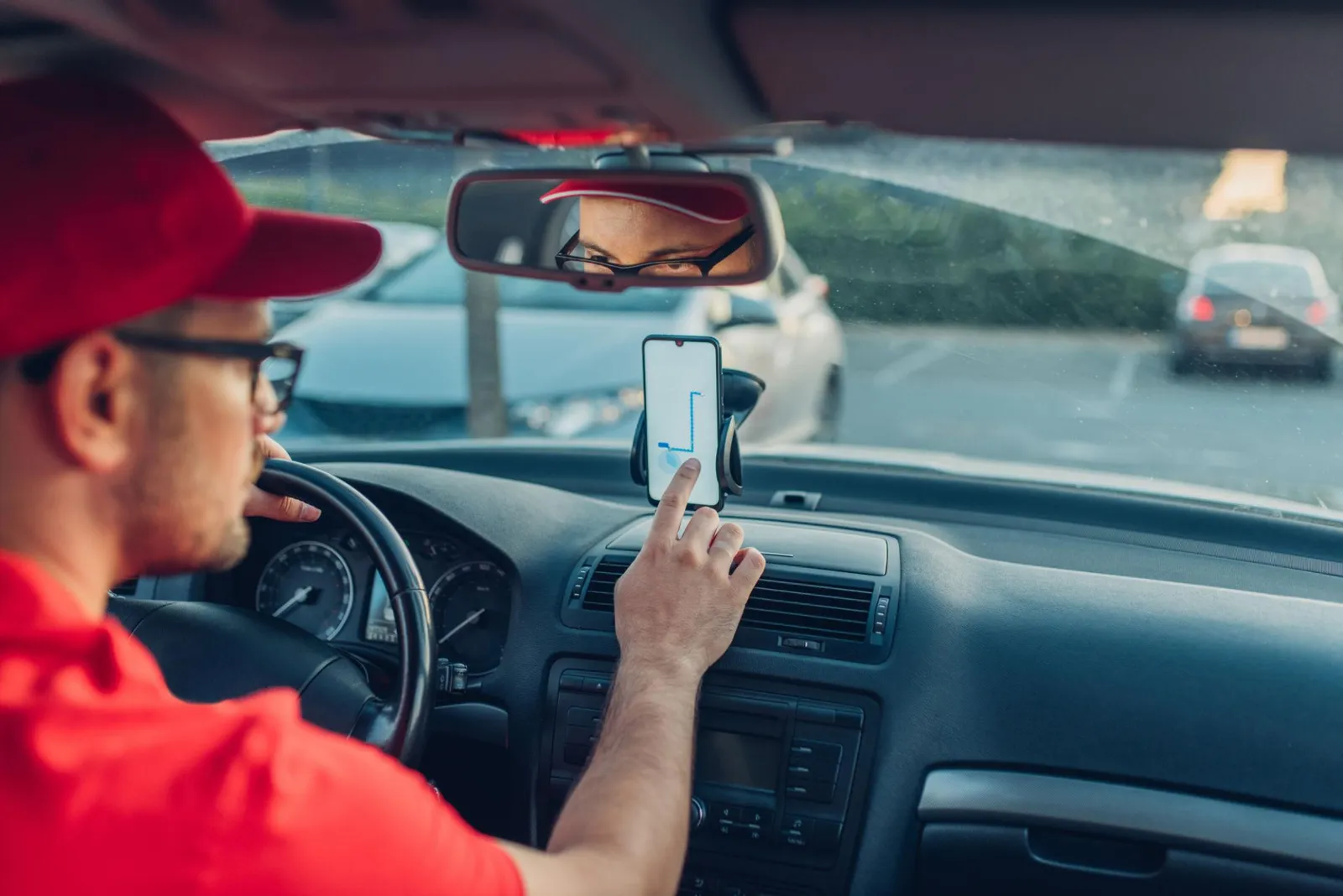 Rideshare driver using a navigation app behind the wheel