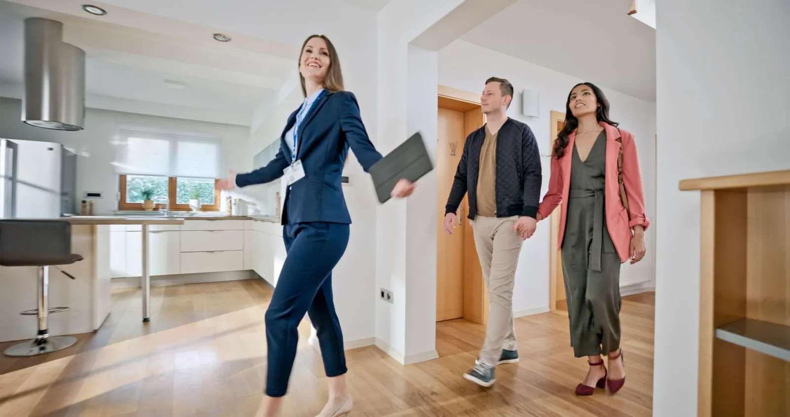Real estate agent showing a home to a young couple