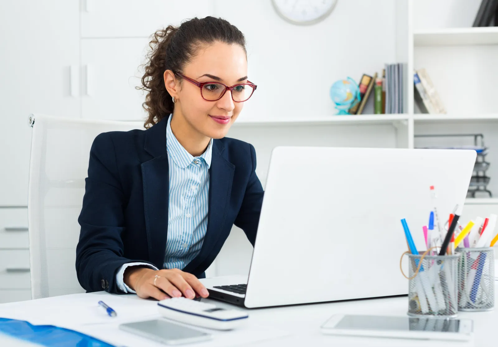 Self-employed professional working on a laptop in her home office