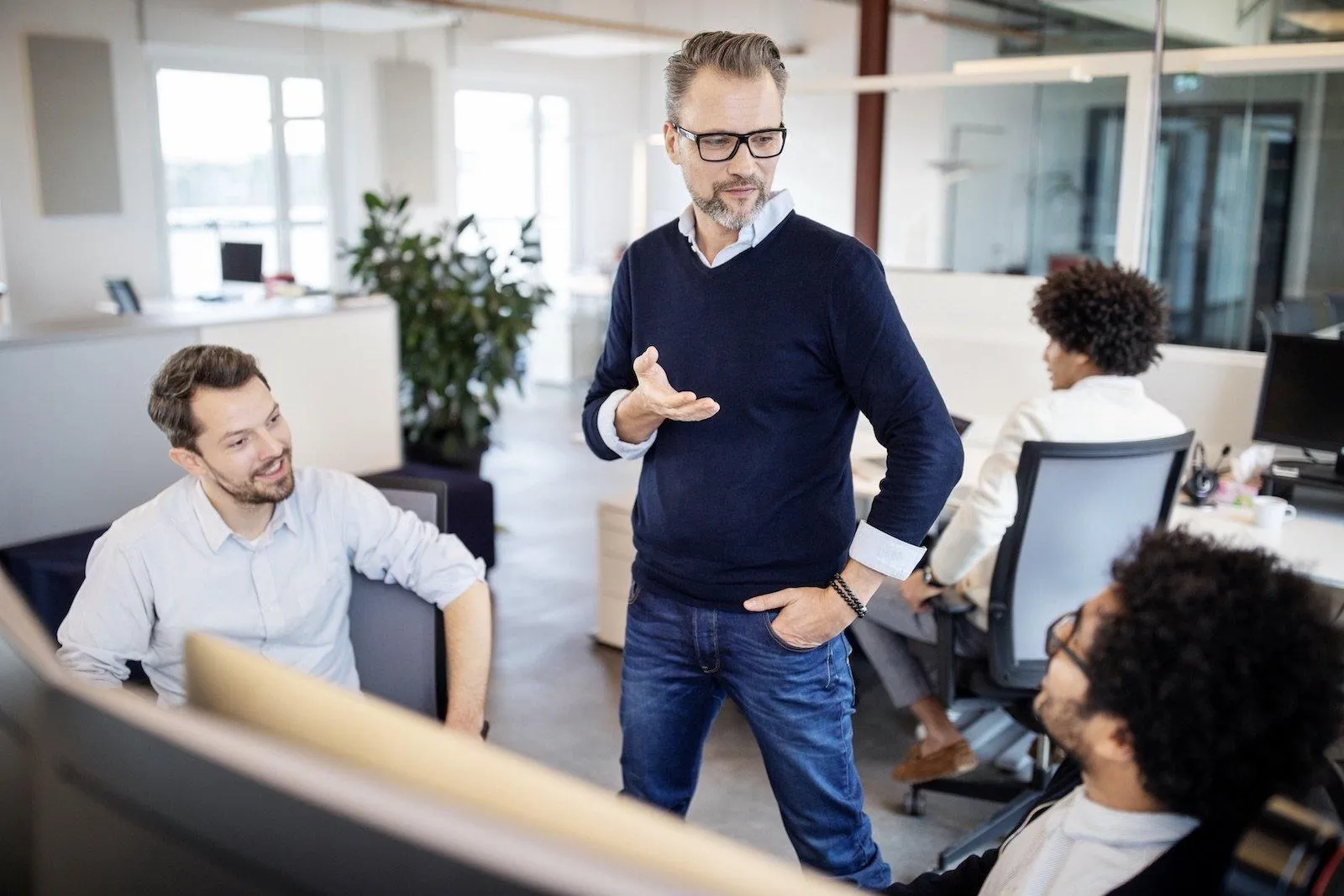 Small business owner leading a team meeting