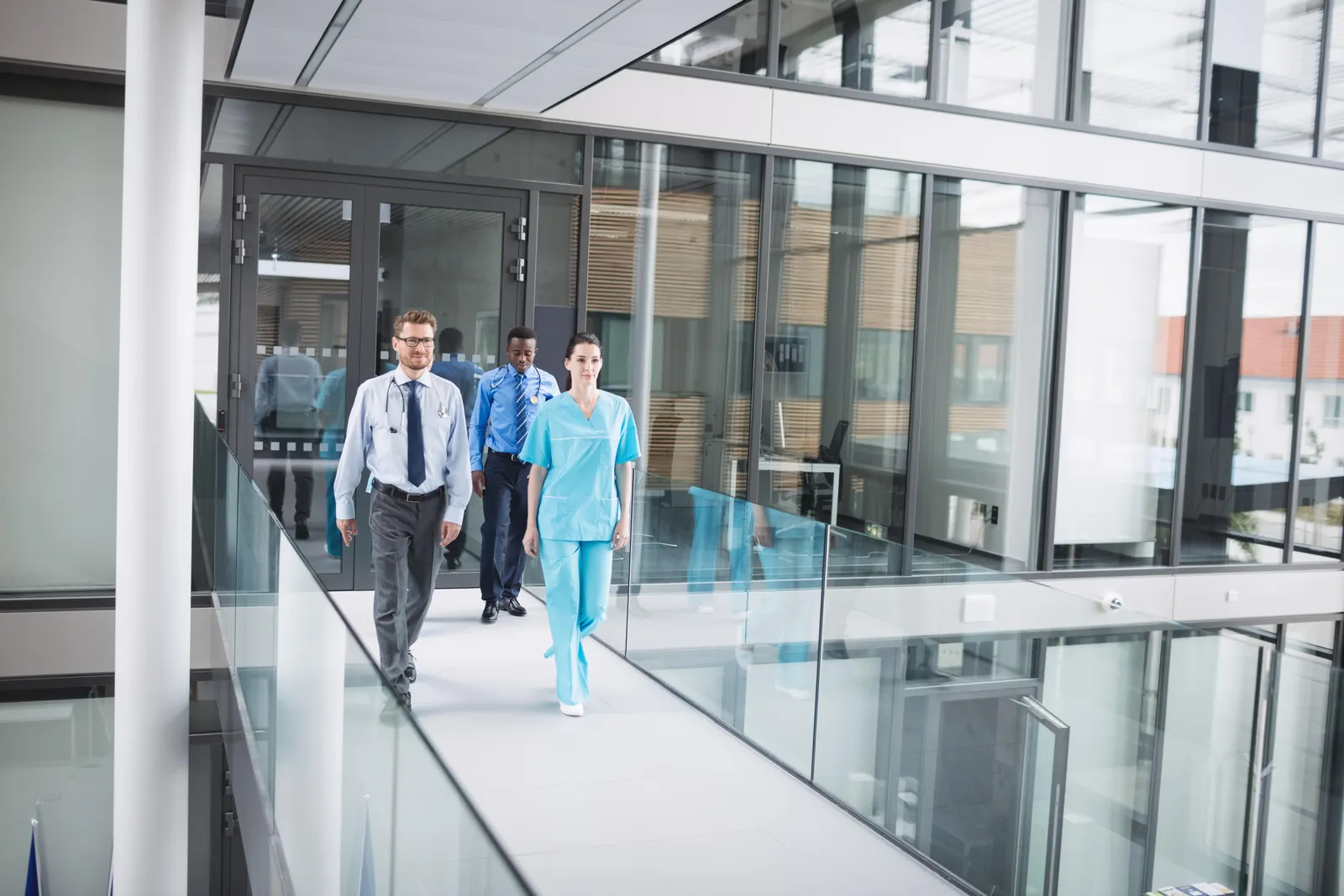 Healthcare staff walking through a hospital corridor